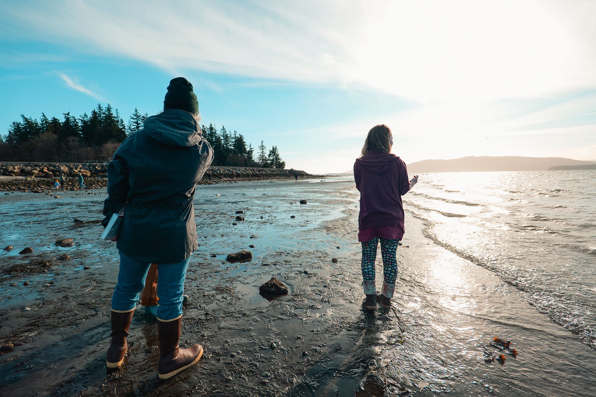 Marine Park beach at sunset showing two beachcombers 
