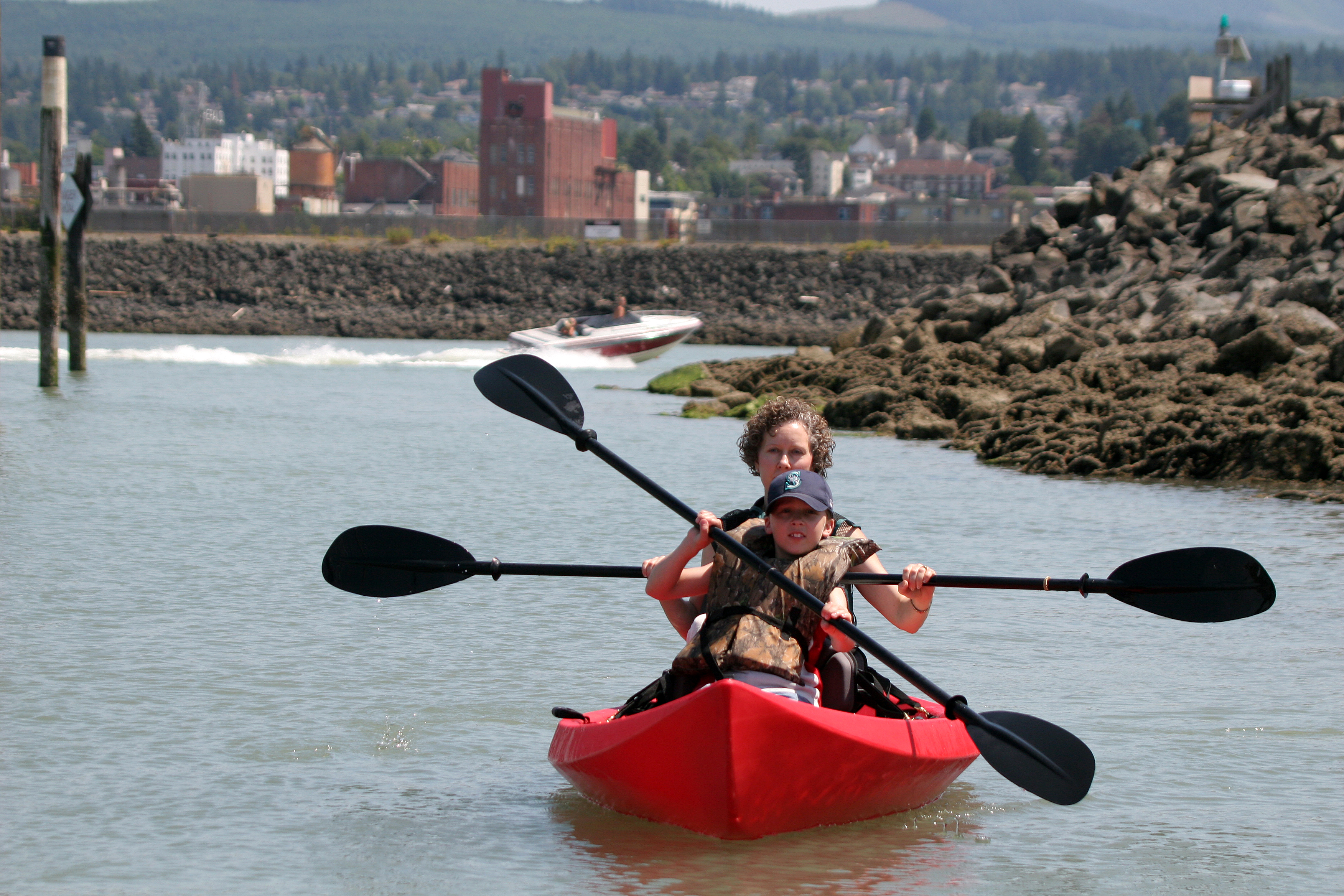 Child and adult paddling in a canoe on the water