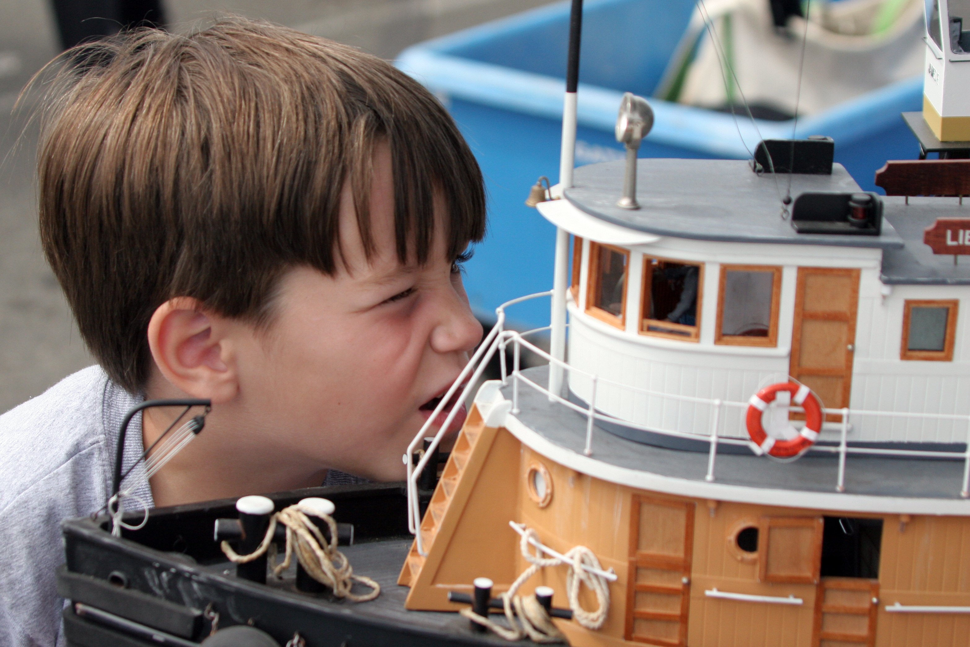 Child looking inside a boat model
